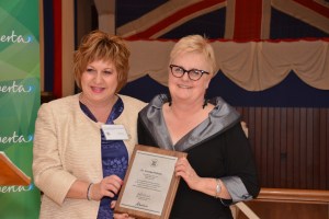 Honourable Heather Klimchuk presenting Dr. Carolee Pollock with plaque at the 2012 AHRF Heritage Awards.
