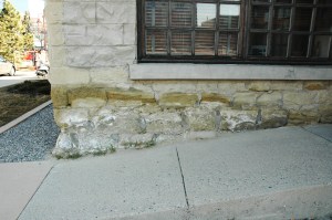 De-icing salts applied to a ramp likely contribute to this sandstone masonry failure.