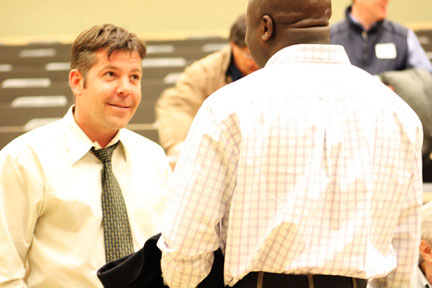 Darryl Bereziuk, speaks with attendees after presenting at a meeting. 