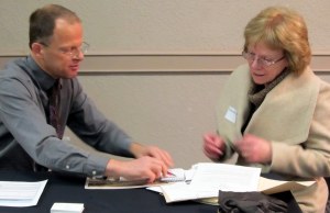 Alberta Culture Heritage Conservation Advisor Fraser Shaw provides information to a property owner at the High River Heritage Inventory Open House.  