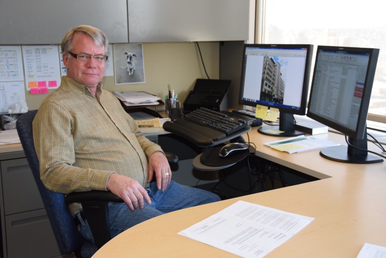 photograph of Larry Pearson, Director of the Historic Places Stewardship Section, at his desk.