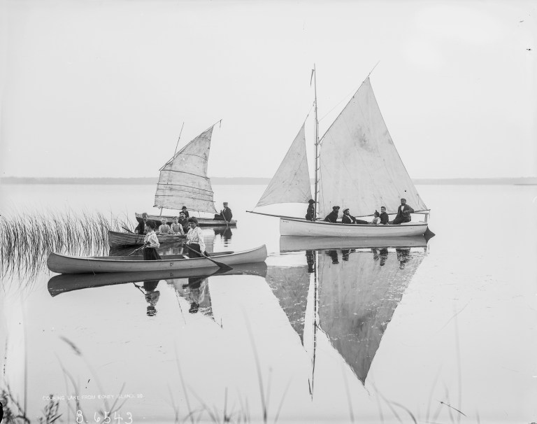The gaff-rigged sloop Mudhen becalmed at Koney Island, along with two canoes, one with a small sail as was popular at the time. (Courtesy of the Provincial Archives of Alberta, B. 6543.)