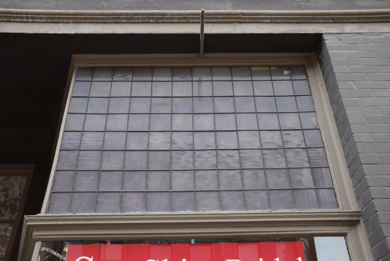 An original prism (or possibly reeded) glass transom window on the Bell Block, a large late commercial style building on Macleod Trail in Calgary (Courtesy of Fraser Shaw, Historic Resources Management Branch). 