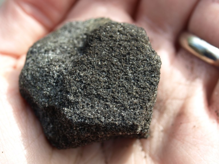 David holding a piece of bitumen (photo by David Martin).