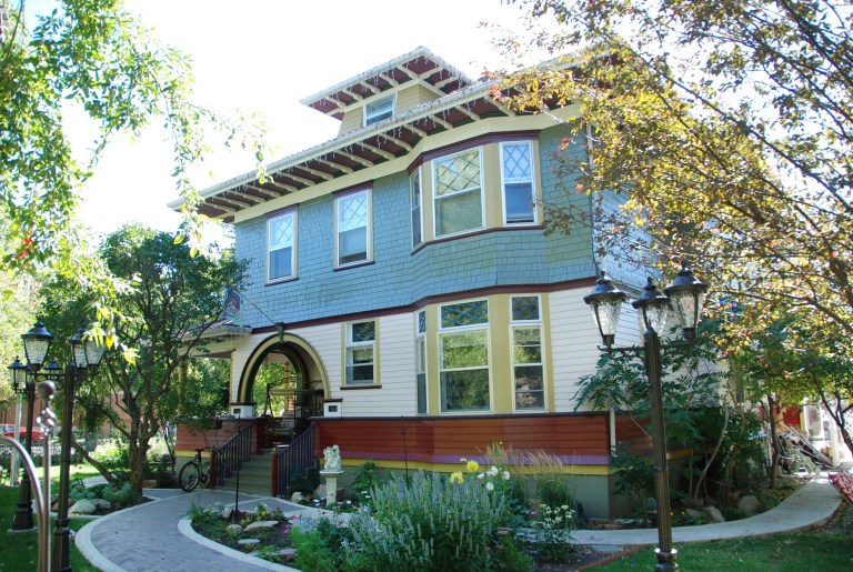 Exterior of Annandale in Lethbridge from the northwest, showing the entry porch with large arches, the wood shingle siding, bow windows and dormer window. September 2009. Alberta Culture and Tourism, Government of Alberta. 