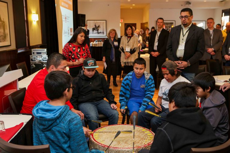 The Crowfoot Young Warriors kick off Moh-Kins-Tsis: Calgary Indigenous Heritage Roundtable with drumming and song. Photo credit: Pinpoint Photography, courtesy of the National Trust for Canada.