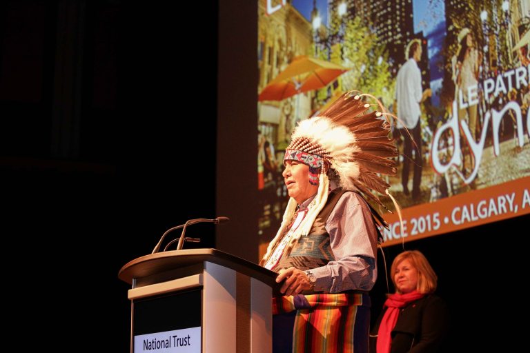 Dr. Reg Crowshoe, spiritual advisor and former Chief of Piikani Nation, provides opening remarks at the conference’s evening keynote session. Photo credit: Pinpoint Photography, courtesy of the National Trust for Canada.