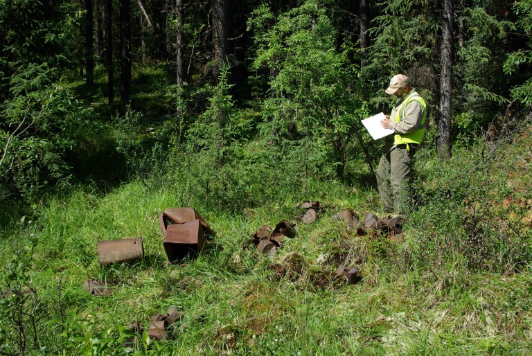 Archaeologist recording a can scatter feature at the site, 2010 (Photo Credit: Lifeways of Canada Ltd.)