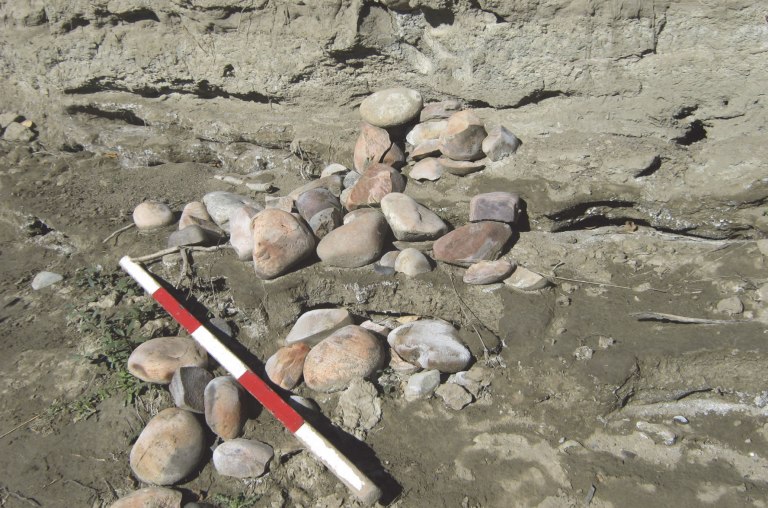 Collapsed remains of an ancient boiling pit, eroding from a riverbank at McKinnon Flats.
