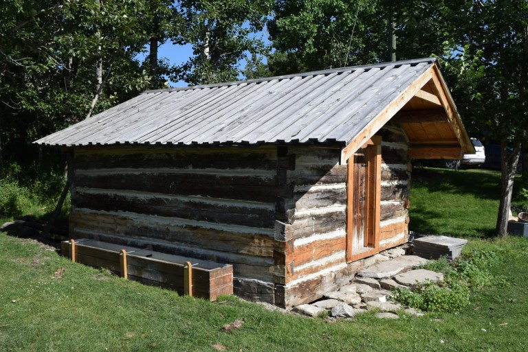 The Spring House upon completion of the conservation work in July 2019, with the horse watering trough reconstructed from fragments of the earlier element. Well-concealed screw pile supports keep the timbers just out of the creek bed and secure the structure in the event of torrential floods from the hills. Source: Historic Resources Management Branch.
