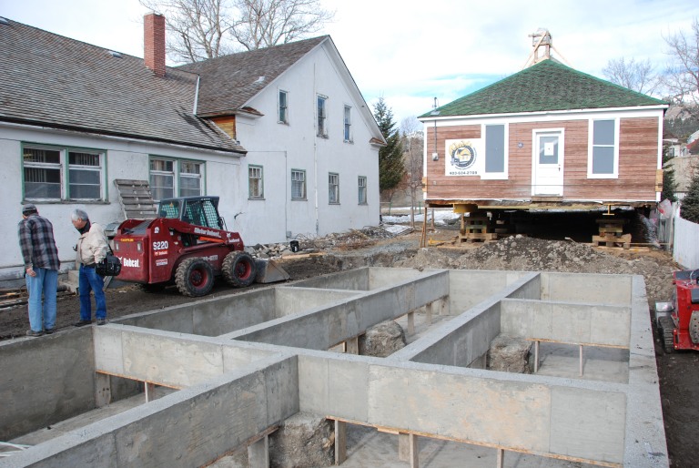 A building needs a “good hat and boots.” The original wood structure(s) sat directly on grade and needed a new foundation. A concrete grade beam and pile foundation was constructed in 2009 and the building was moved approximately 1 metre west for more space along the east wall, where a gap of mere inches from the neighbouring residence prevented any access for rehabilitation or maintenance. The move was limited to ensure the west side remained basically as it was in 1922.  A substantial crawl space within the foundation provides space for new heating systems and ducts. 