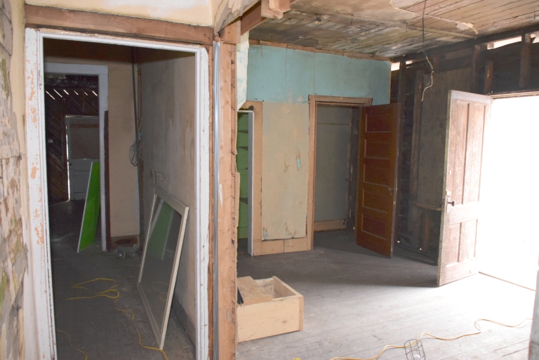 In June 2016, the interior had suffered extensive water damage from roof leaks and moisture penetration through the exterior walls. A welter of finishes recorded decades of change and included the varnished tongue-and-groove walls and ceilings of the former APP office, linoleum flooring and wallpapers dating from the 1930s to the 1960s, and many layers of lead paint. 